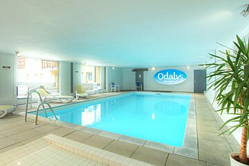 A swimming pool with a odalys sign on the wall