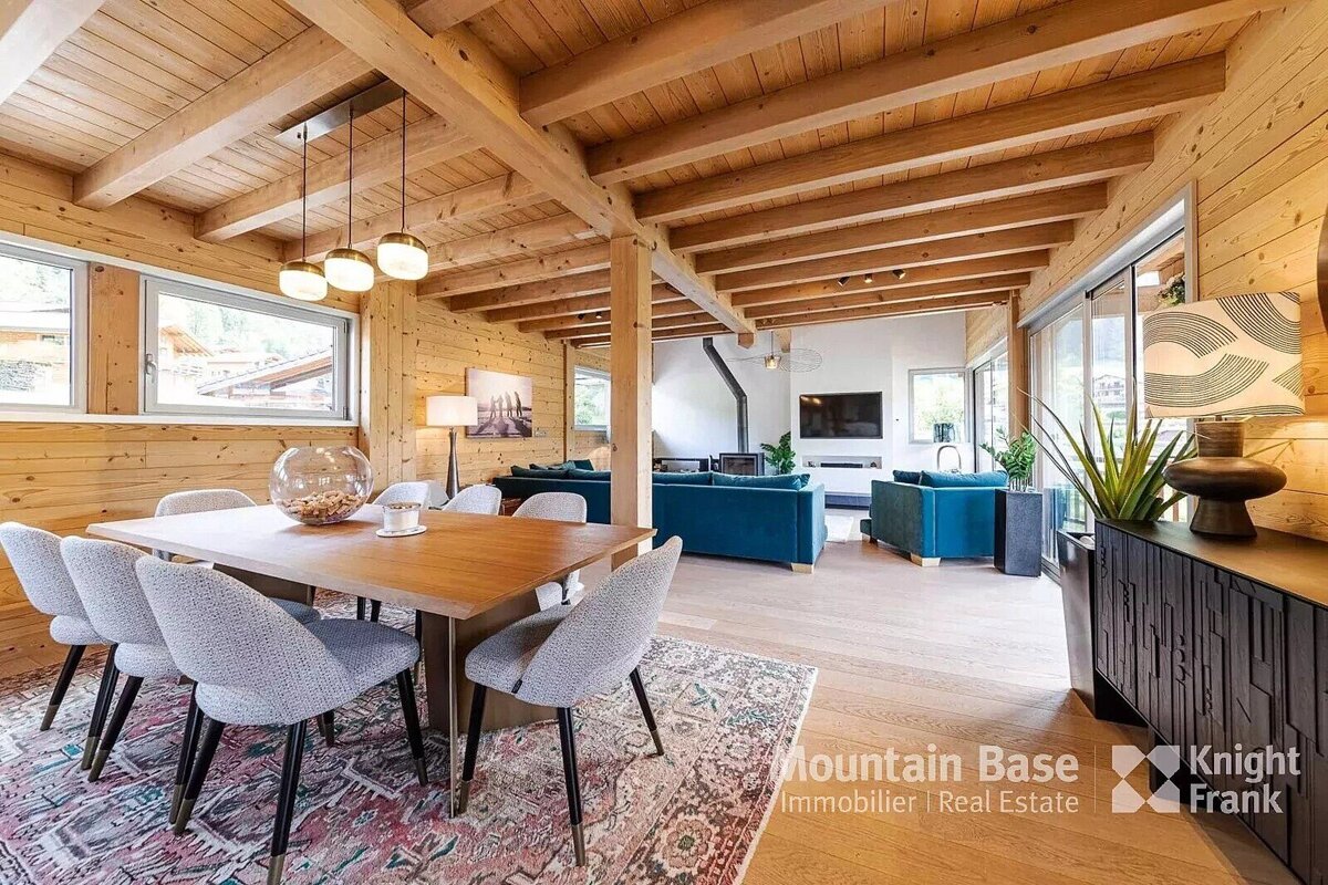 A living room with a table and chairs and the words mountain base on the bottom