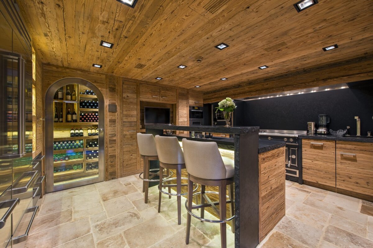 A kitchen with wooden cabinets and a wine cooler