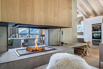 A fireplace with a view of the mountains behind it