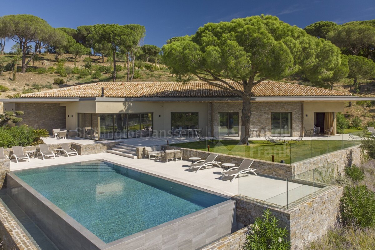 A large house with a large swimming pool in front of it