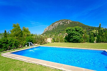 A large swimming pool with a mountain in the background