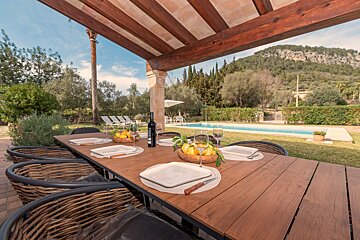 A wooden table with a bottle of wine on it