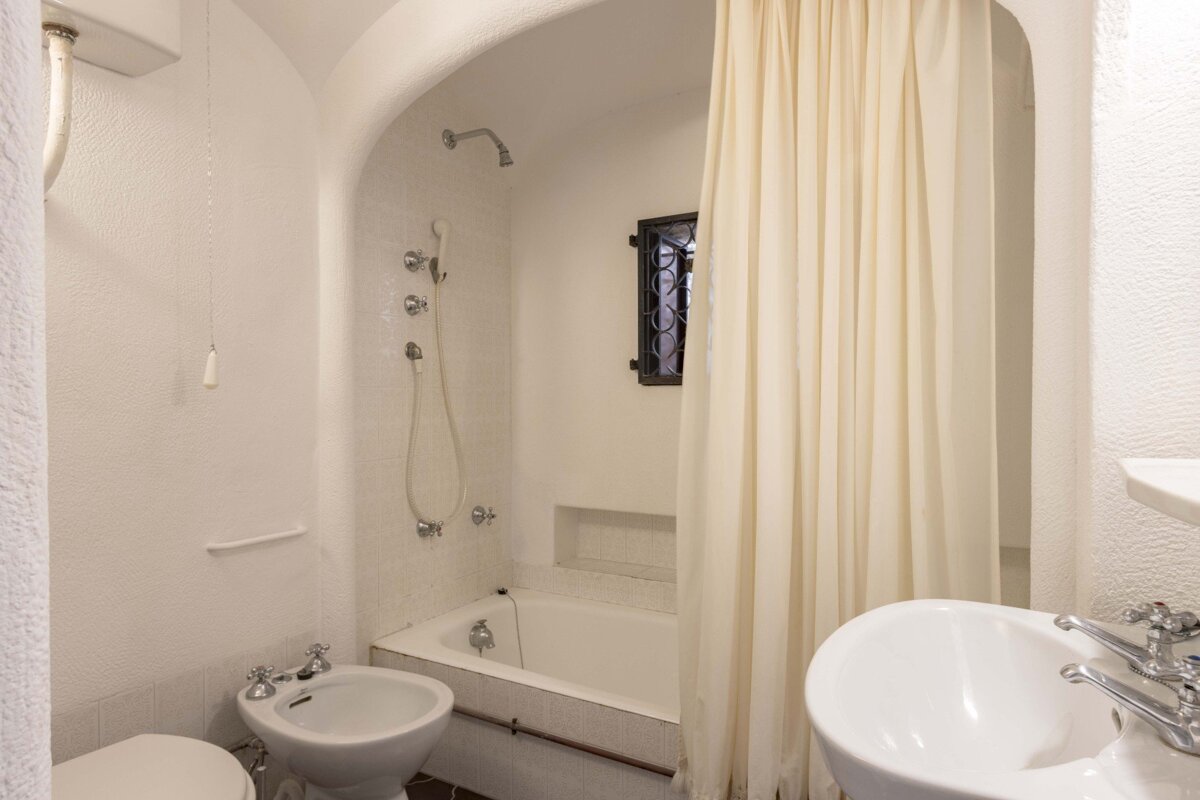 A bathroom with a toilet bidet and sink