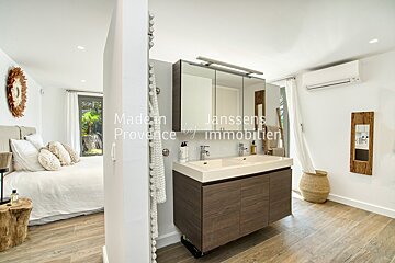 A bathroom with two sinks and the words made in provence on the wall