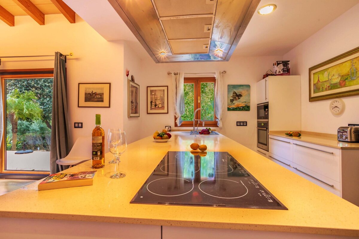A bottle of wine sits on a counter in a kitchen