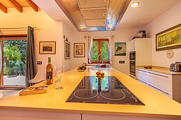 A bottle of wine sits on a counter in a kitchen