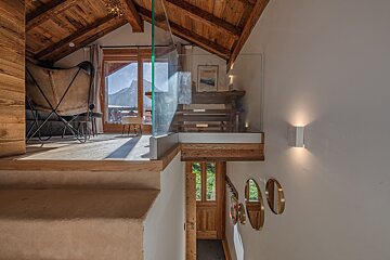 A bathroom with a washing machine and a toilet