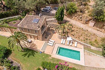 An aerial view of a house with a swimming pool