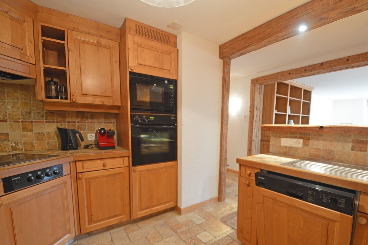 A kitchen with wooden cabinets and a siemens dishwasher