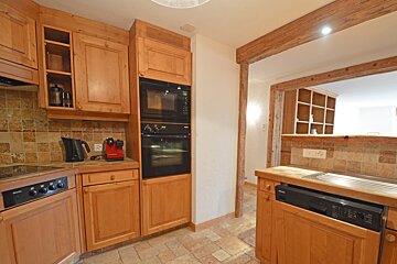 A kitchen with wooden cabinets and a siemens dishwasher