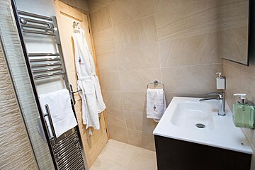A bathroom with a sink and a towel rack