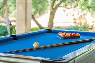 A pool table with balls and cues on it