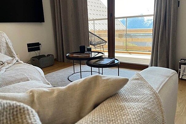 A living room with a couch and two tables