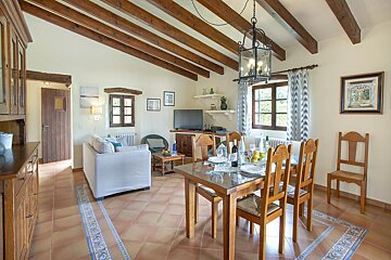 A living room with a dining table and chairs