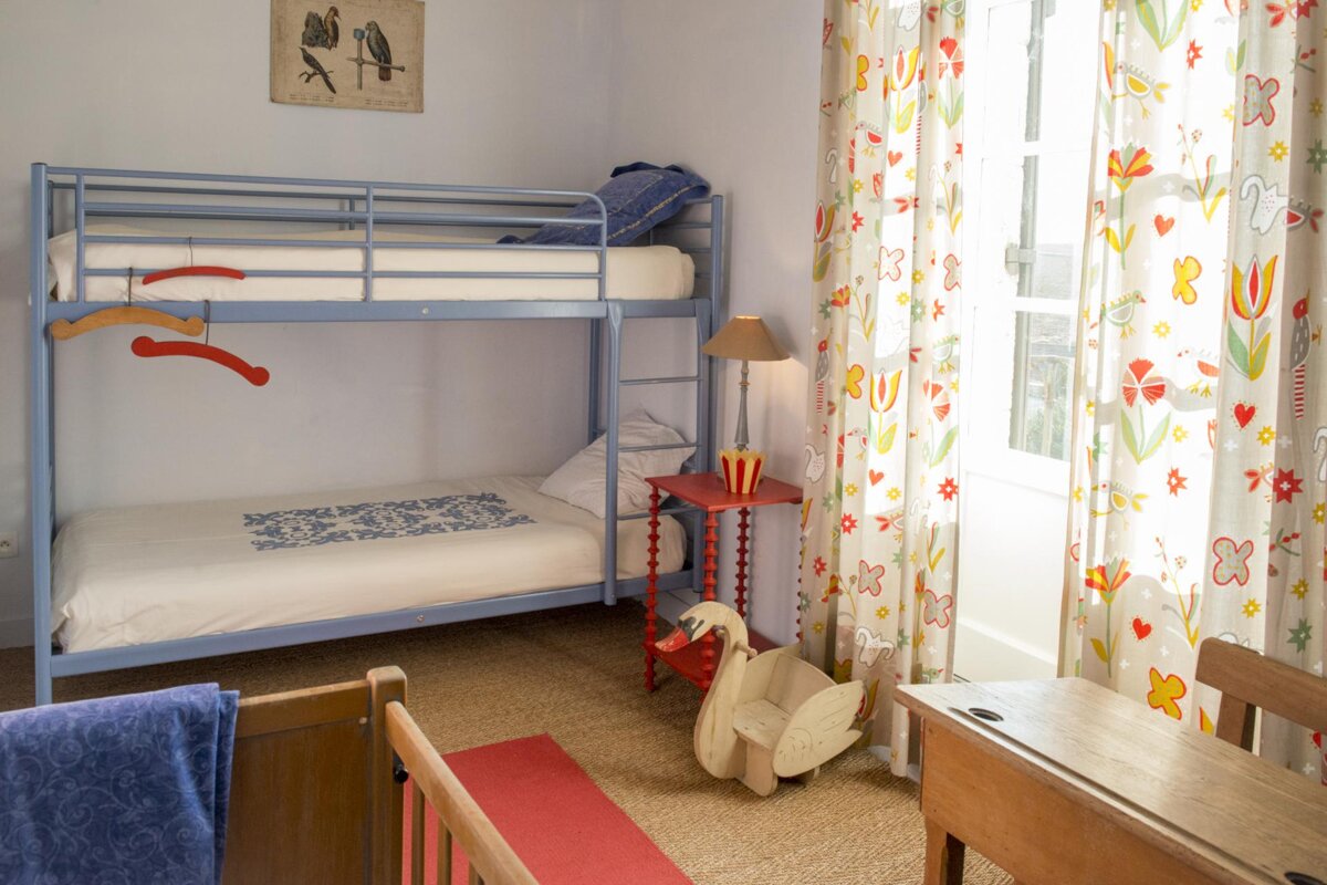 A child 's bedroom with a bunk bed and a desk