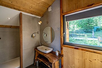 A bathroom with a sink a mirror and a window