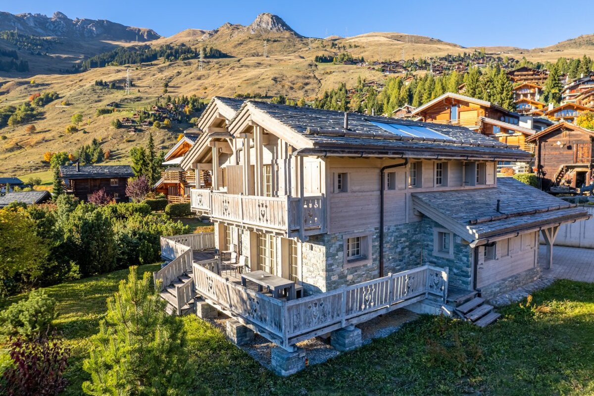 A large house with a mountain in the background