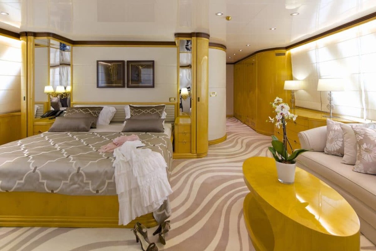A bedroom with a large bed and a yellow coffee table