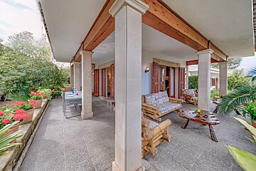 A patio with a table and chairs on it