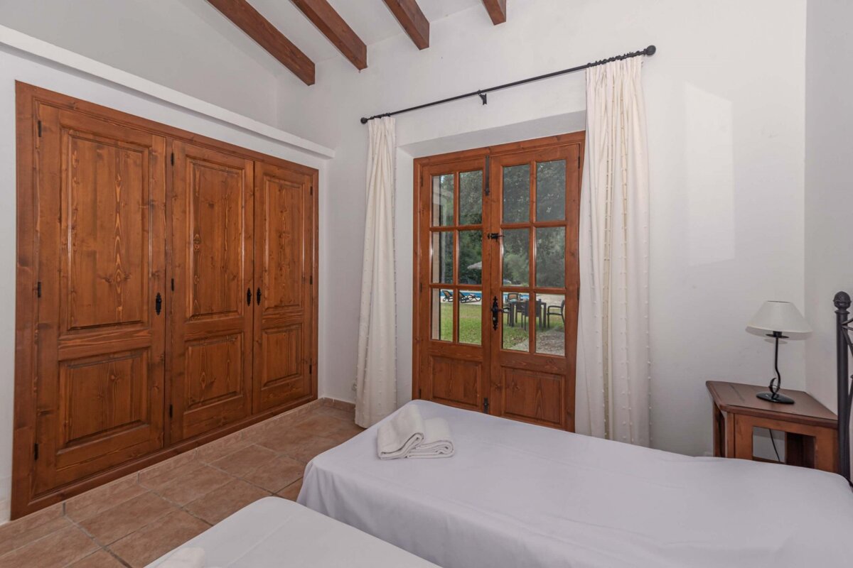 A bedroom with two beds and a large closet