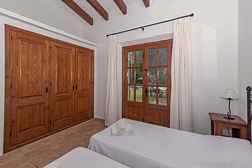 A bedroom with two beds and a large closet