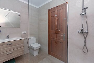 A bathroom with a toilet a sink and a shower