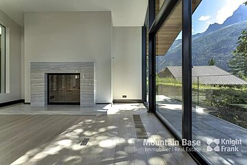 A living room with a fireplace and a knight frank logo
