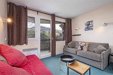 A living room with a couch and a deer pillow