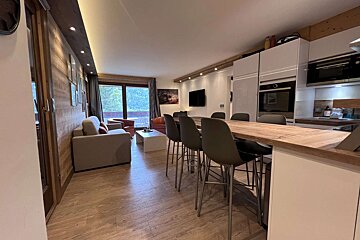 A living room with a couch and a table and chairs