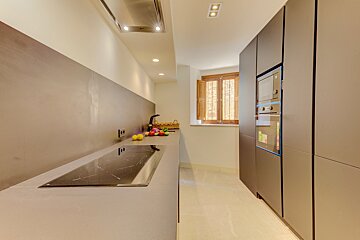 A kitchen with a stove top oven and a microwave