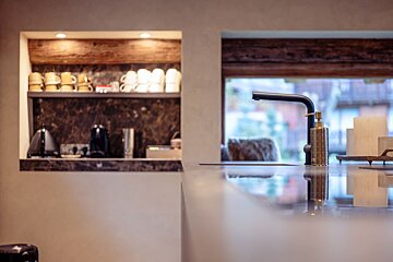 A kitchen counter with a soap dispenser on it