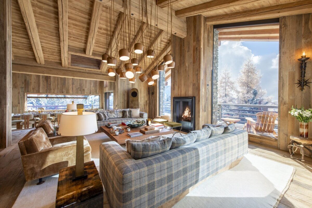 A living room with a couch and chairs and a fireplace