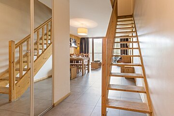 A wooden staircase leading up to the second floor of a house