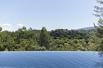 A swimming pool with a view of a village in the distance