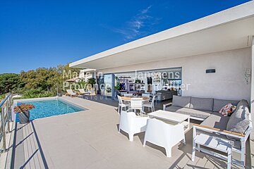 A patio with a swimming pool and a table and chairs and a sign that says made in provence