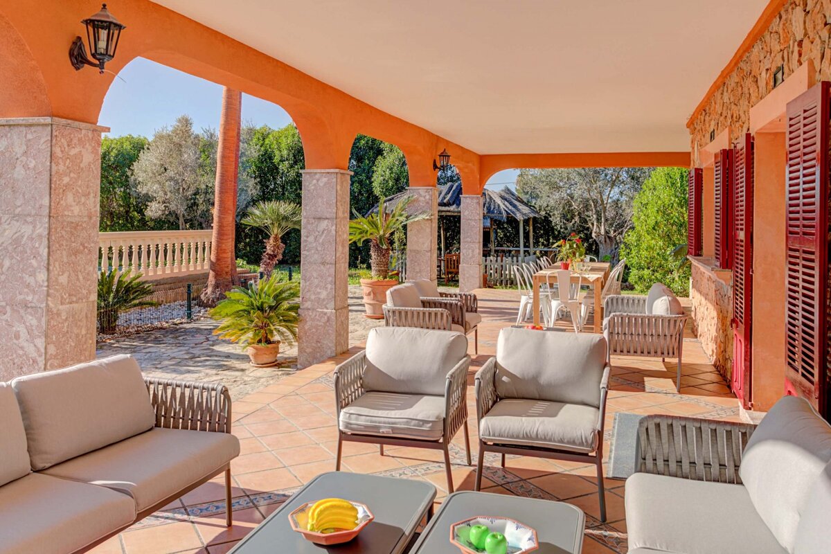 A patio with a couch and chairs and a table