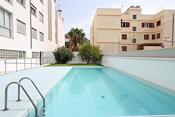 A large swimming pool surrounded by tall buildings