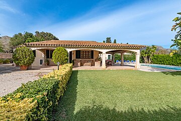 A house with a large lawn in front of it