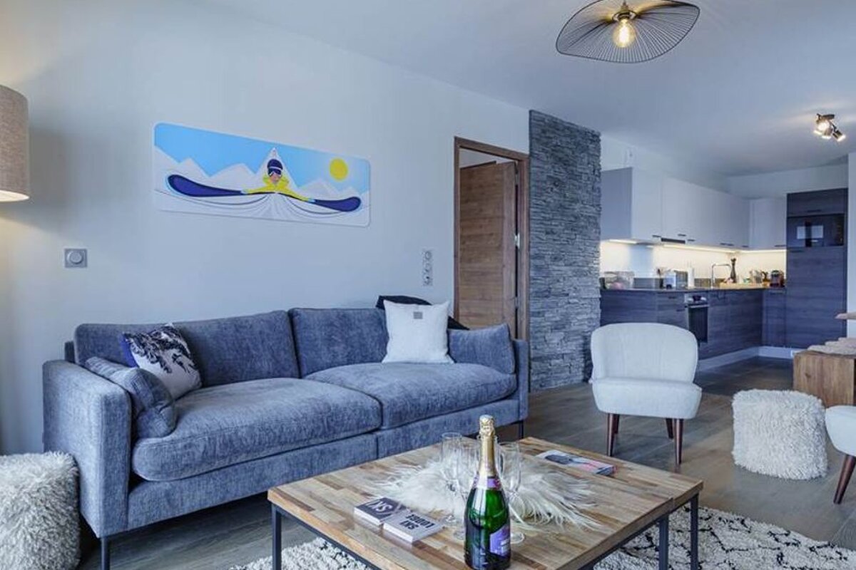 A bottle of champagne sits on a coffee table in a living room
