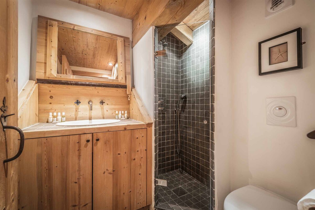 A bathroom with a sink and a walk in shower