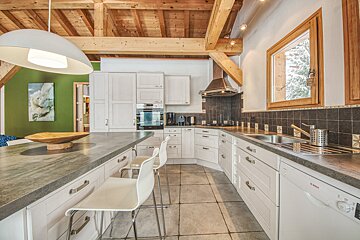 A kitchen with white cabinets and a bosch dishwasher