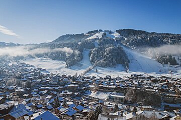 A snowy mountain with a ski slope in the background