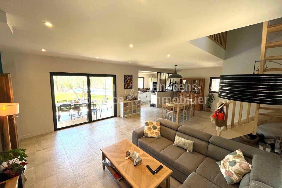 A living room with a couch a coffee table and a sign that says immobilier