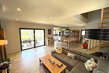 A living room with a couch a coffee table and a sign that says immobilier