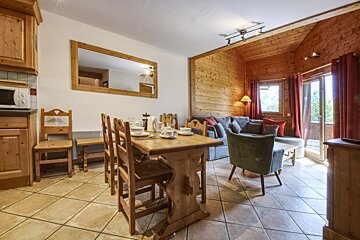 A living room with a dining table and chairs