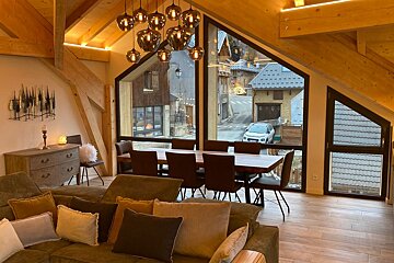 A living room with a couch and a dining table