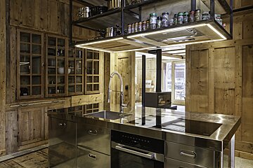 A kitchen with stainless steel appliances and wooden cabinets
