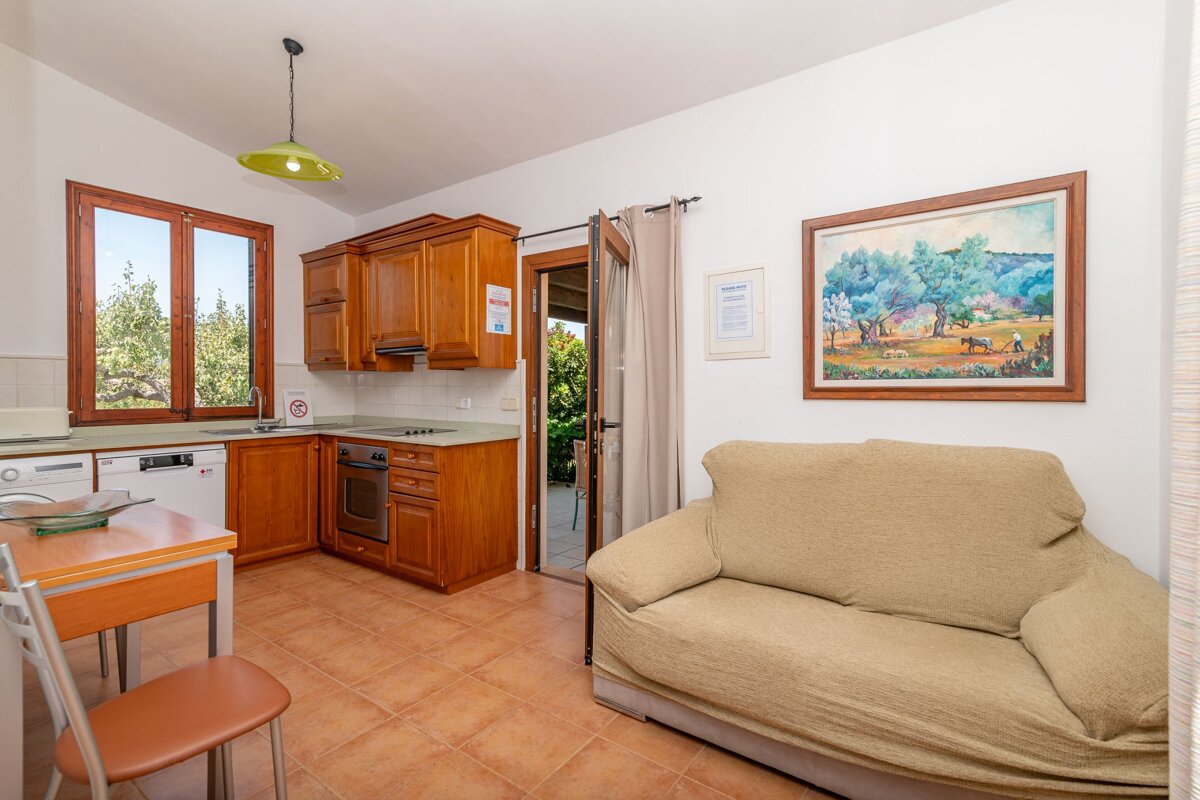 A living room with a couch and a painting on the wall