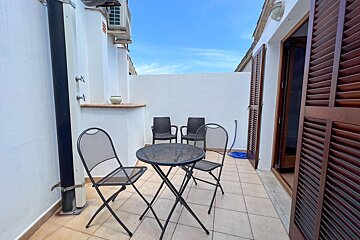 A small patio area with a table and chairs